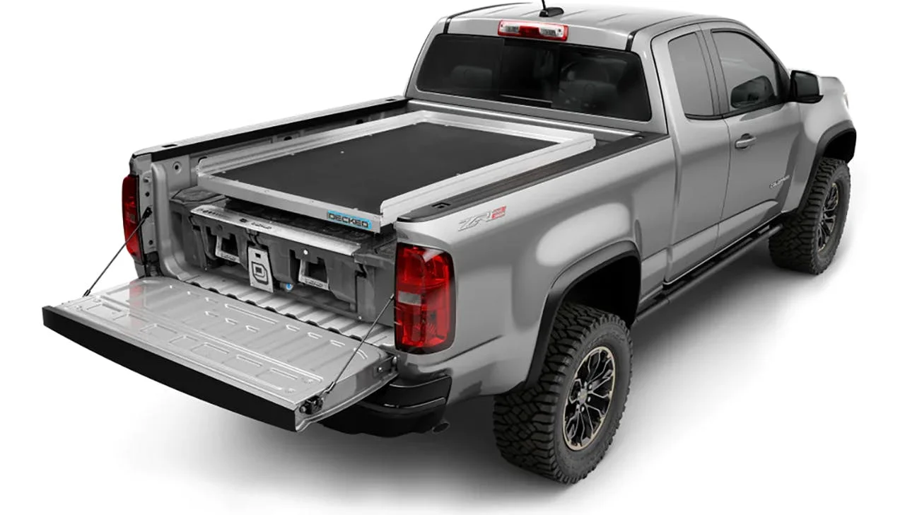 Silver pickup truck with open tailgate showing sliding cargo tray system installed in truck bed