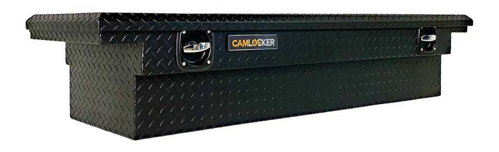 Black CamLocker crossover toolbox with diamond plate steel surface and central locking mechanism mounted above truck bed.