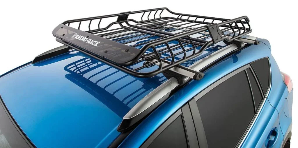 Black metal roof cargo basket mounted on blue SUV with silver roof rails and black padding on front edge.
