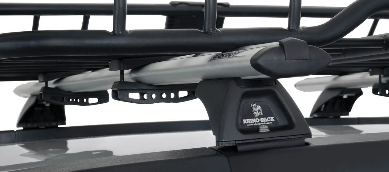 Rhino-Rack roof basket with silver aluminum slats and black mounting brackets secured to truck roof rails
