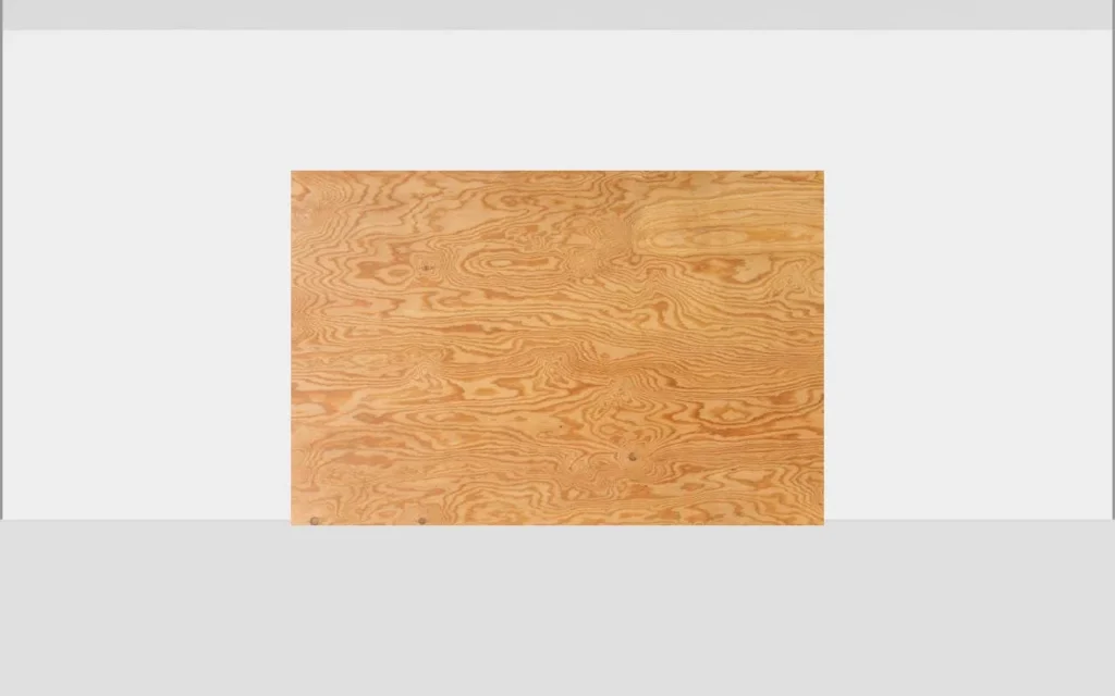 Sheet of plywood with wood grain texture leaning against a wall for headlight adjustment testing