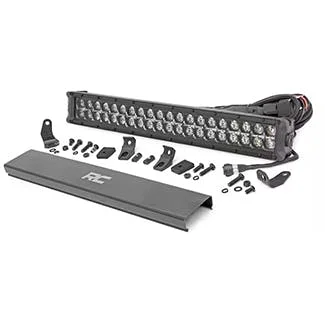 LED light bar with mounting brackets and hardware kit laid out separately on gray surface