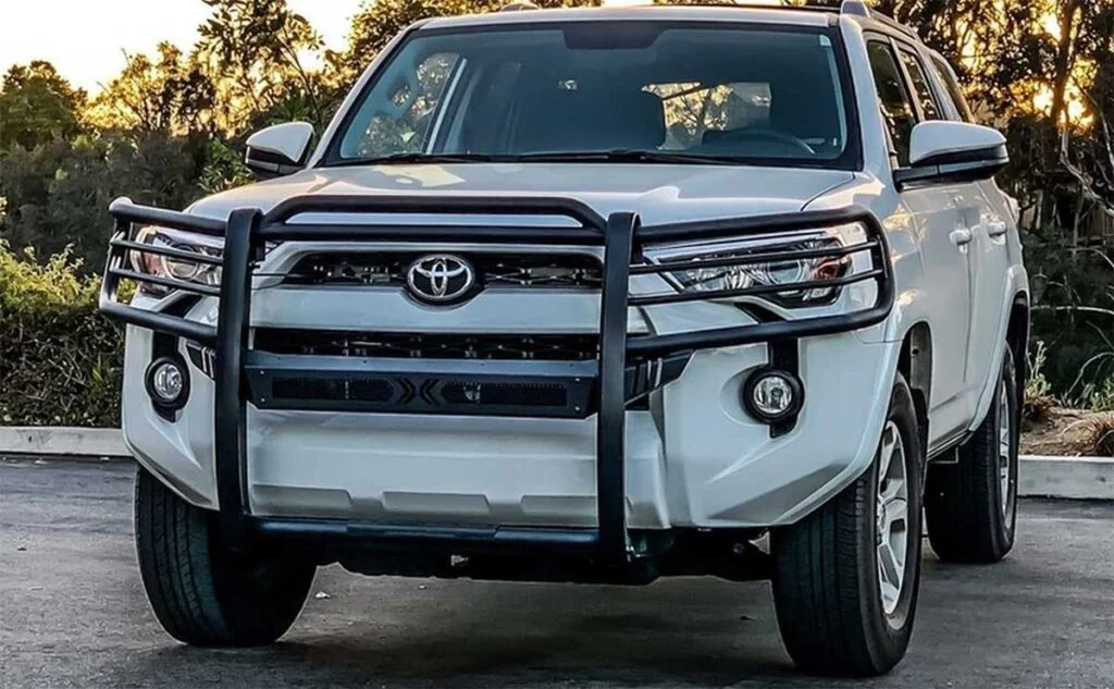 White Toyota 4Runner SUV with black metal grille guard protecting the front bumper and radiator