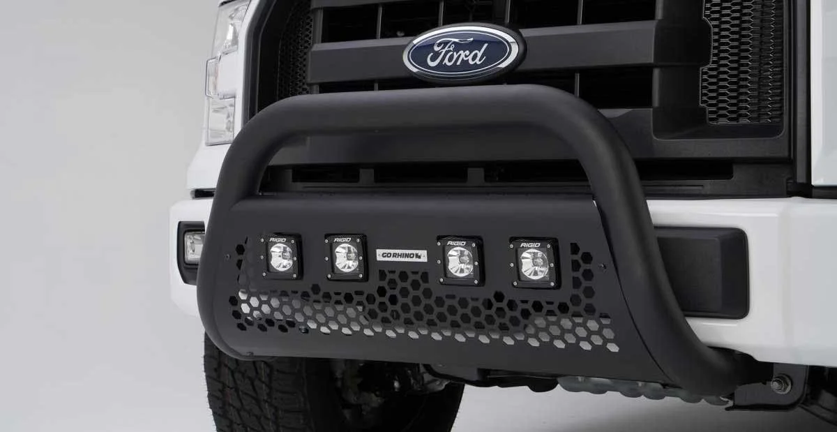 Black powder-coated grille guard with four integrated LED work lights mounted on white Ford truck front end