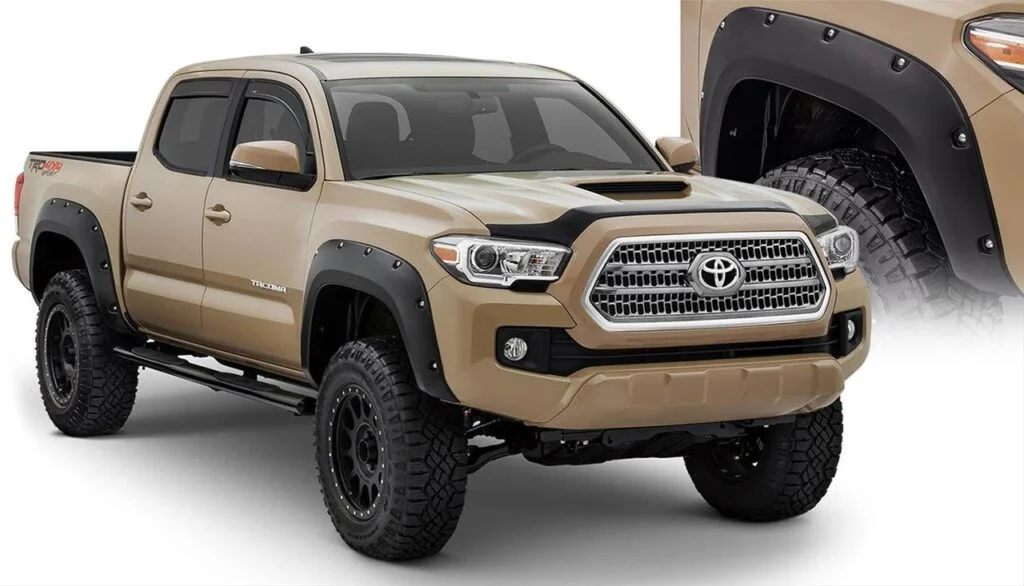 Tan Toyota Tacoma with black bolt-on fender flares, lifted suspension, and all-terrain tires, shown with flare detail on