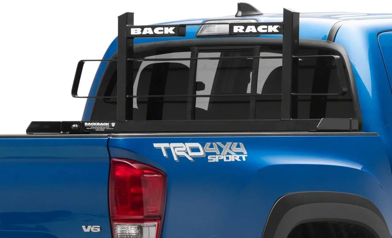 Black headache rack mounted on blue pickup truck bed with vertical bars and "BACK RACK" branding visible