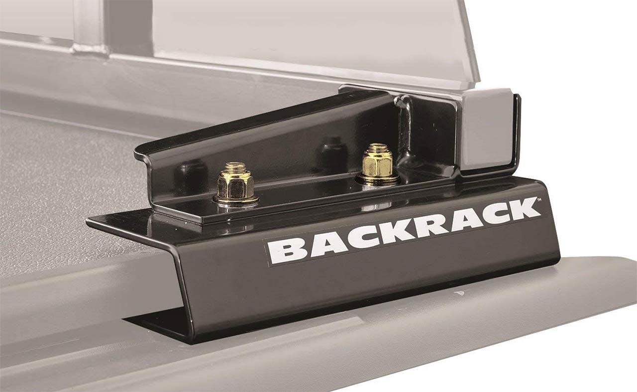 Black Backrack headache rack with open storage compartment and brass-colored mounting hardware installed on truck bed