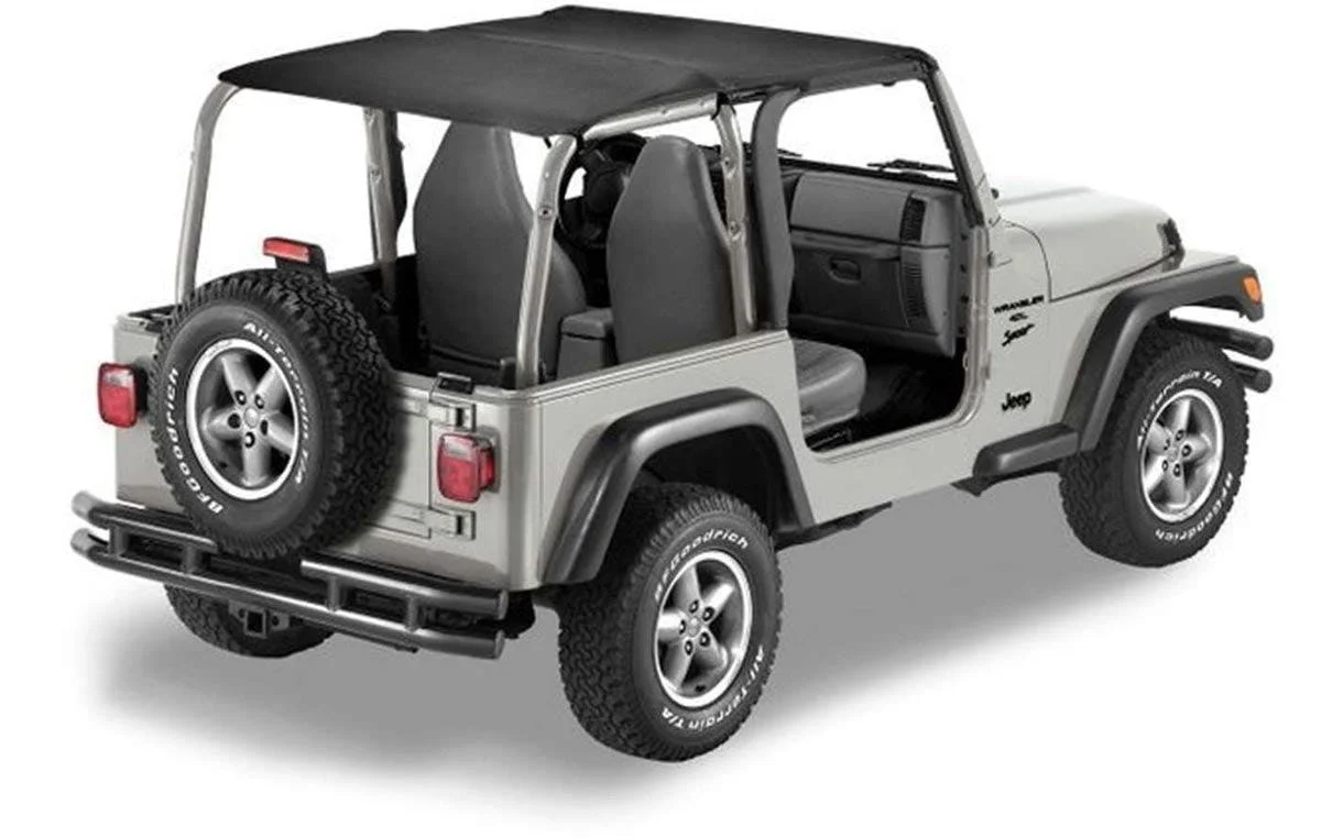 Silver Jeep with doors removed, black soft top, and exposed interior seating viewed from the side.