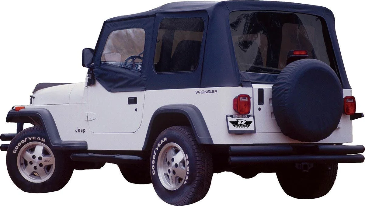 White and navy Jeep Wrangler with soft top and spare tire mounted on rear