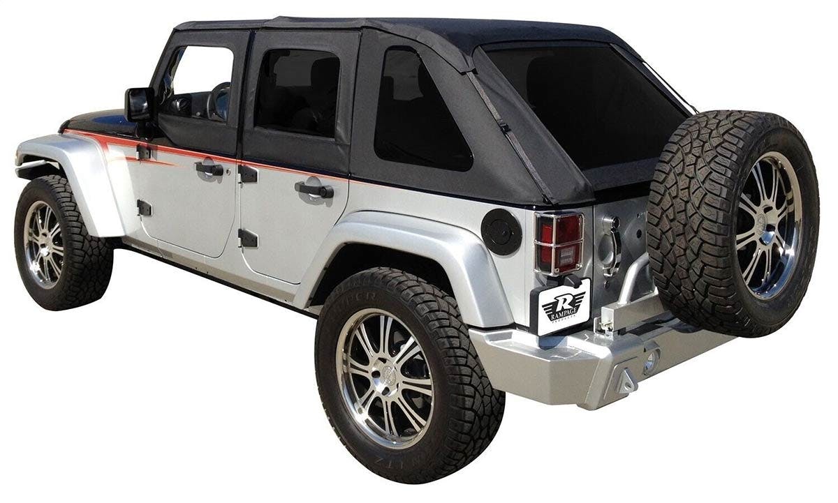 White four-door Jeep with black soft top and custom silver spare tire carrier on rear bumper.