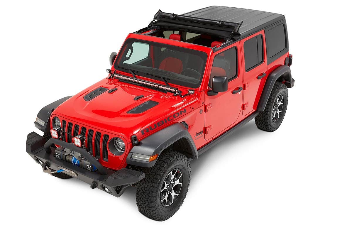 Red Jeep Wrangler with black soft top, LED light bar, and black bumper displayed against white background