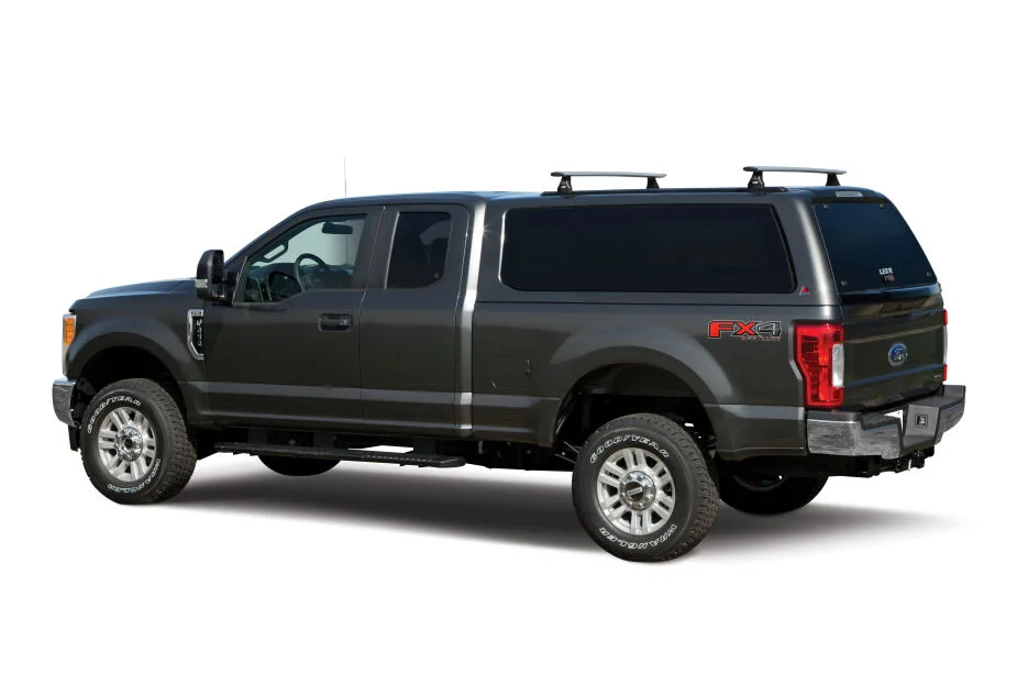 LEER 100XQ truck cap on a charcoal Ford F-250 Super Duty FX4, driver side view