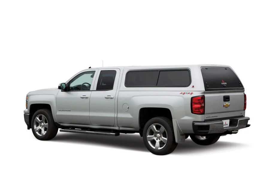LEER 100XR truck cap on a silver Chevrolet Silverado double cab, driver side view