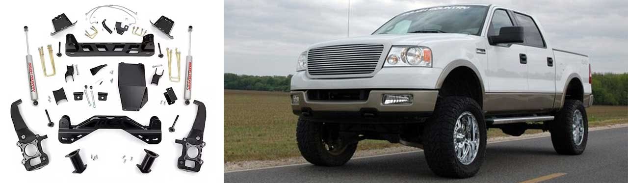 Suspension lift kit components laid out including brackets, shocks, and hardware next to lifted white pickup truck
