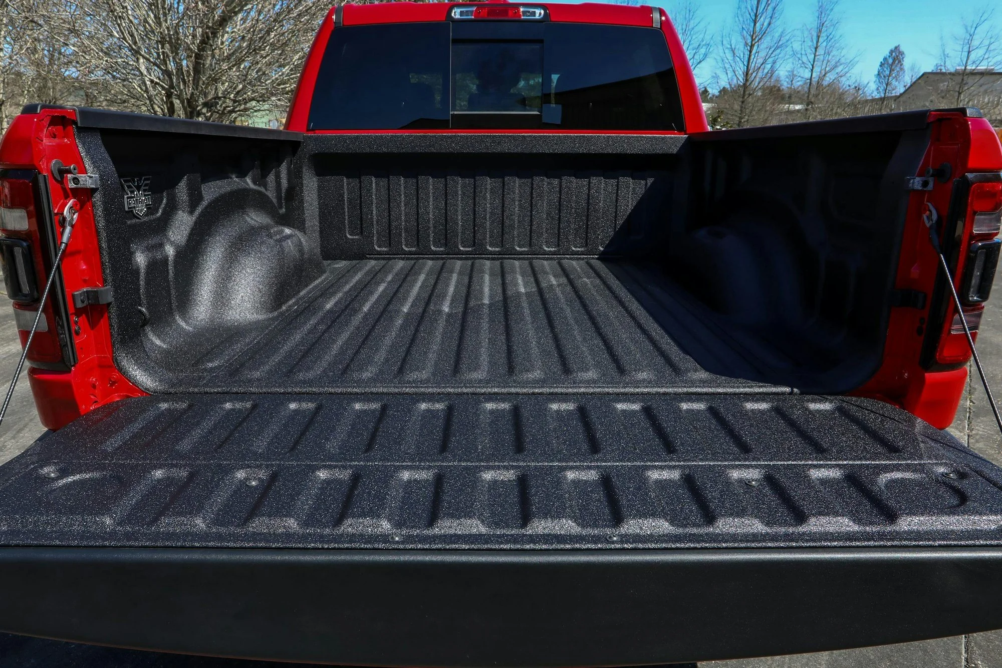 Low pressure spray-in bedliner with a smooth consistent finish