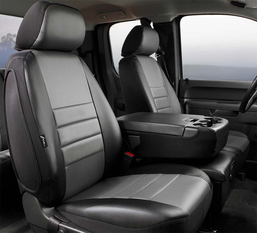Gray and black leather seat covers installed on truck front seats with headrests and center console visible