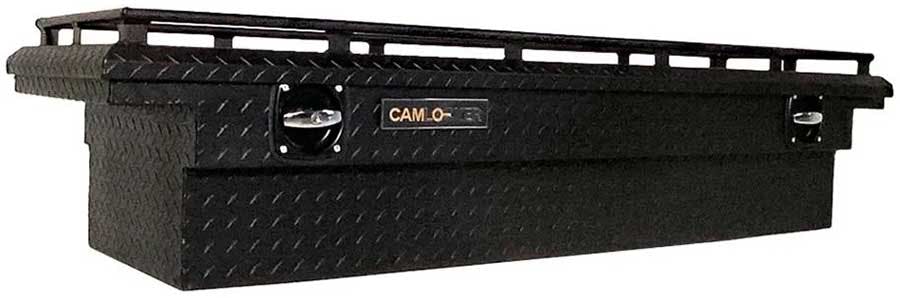 Black steel truck bed toolbox with diamond plate surface, top rails, and front latch mechanisms for securing cargo.