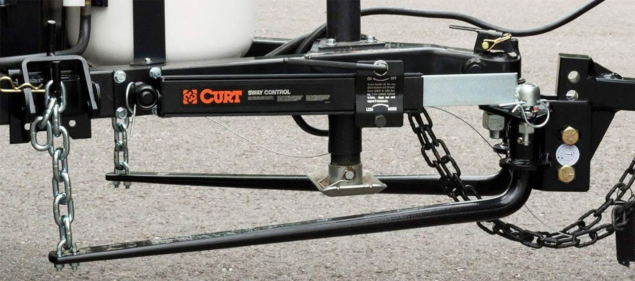 Curt sway control hitch with chains, mounted on truck receiver with control arm and friction hardware visible
