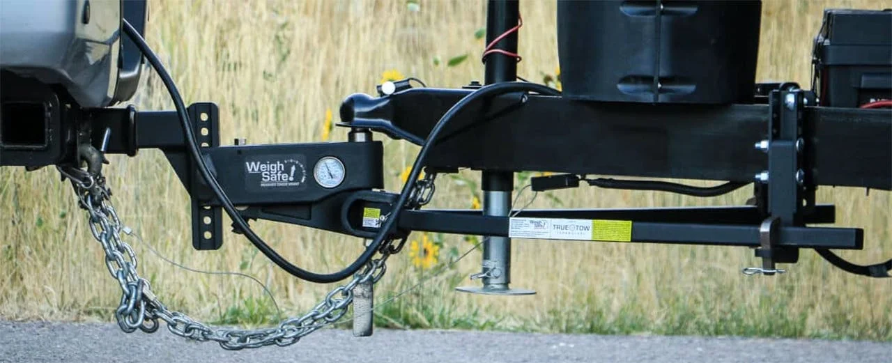 Weight distribution hitch with chains and Weigh Safe gauge attached to truck receiver