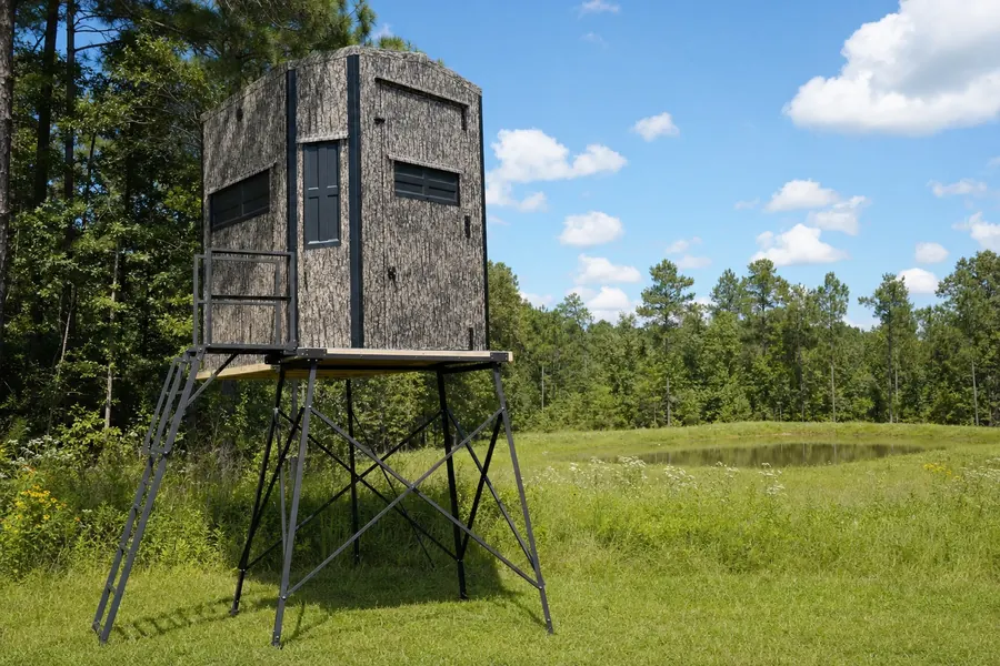 Shadow Hunter blind on a steel Elevator tower with stair and platform, overlooking a green food plot