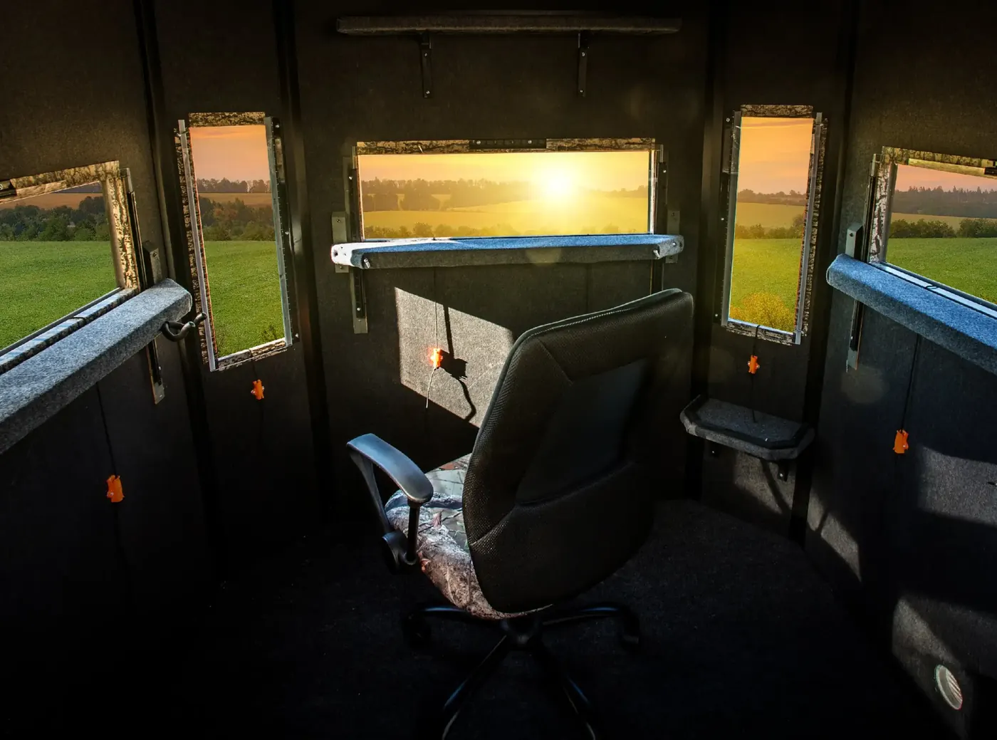 Inside a Shadow Hunter 6x6 Octagon blind: carpeted walls and floor, padded shooting rails and windows open on every side