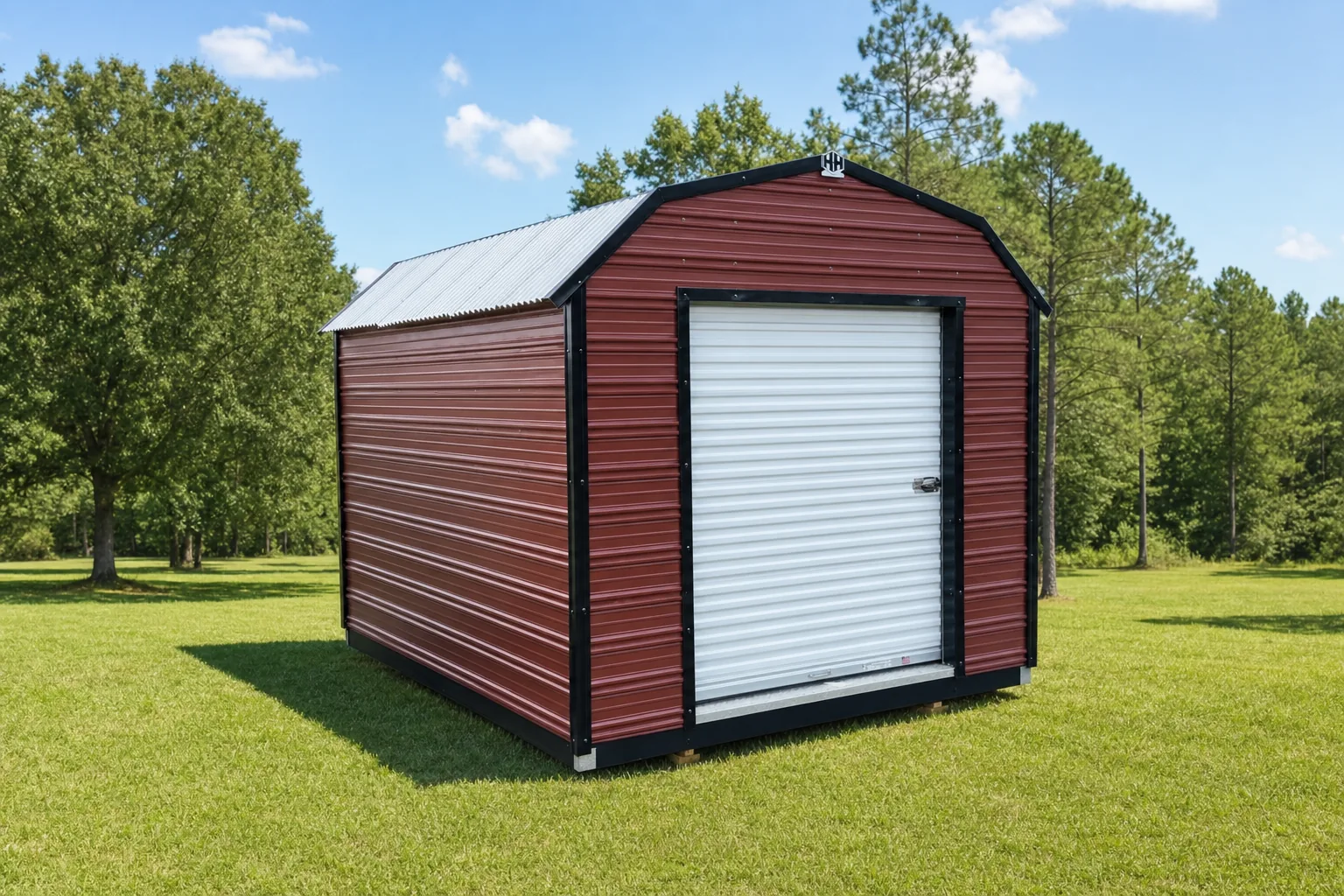 Rustic Red H&H barn-style aluminum shed with black trim, a white roll-up door and a galvalume roof, standing on a mown lawn
