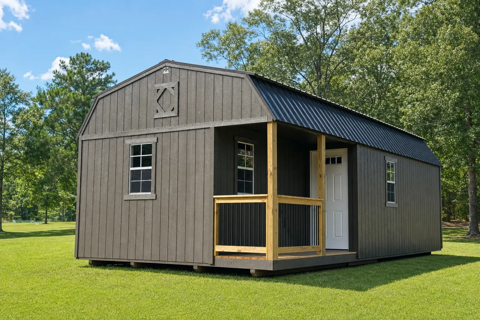 H&H lofted barn cabin in taupe with a charcoal metal barn roof and a covered pressure-treated pine porch