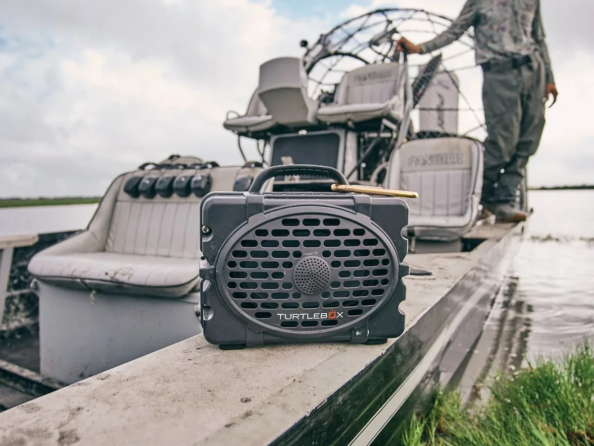 Turtlebox speaker sitting on the gunwale of an airboat out on the marsh